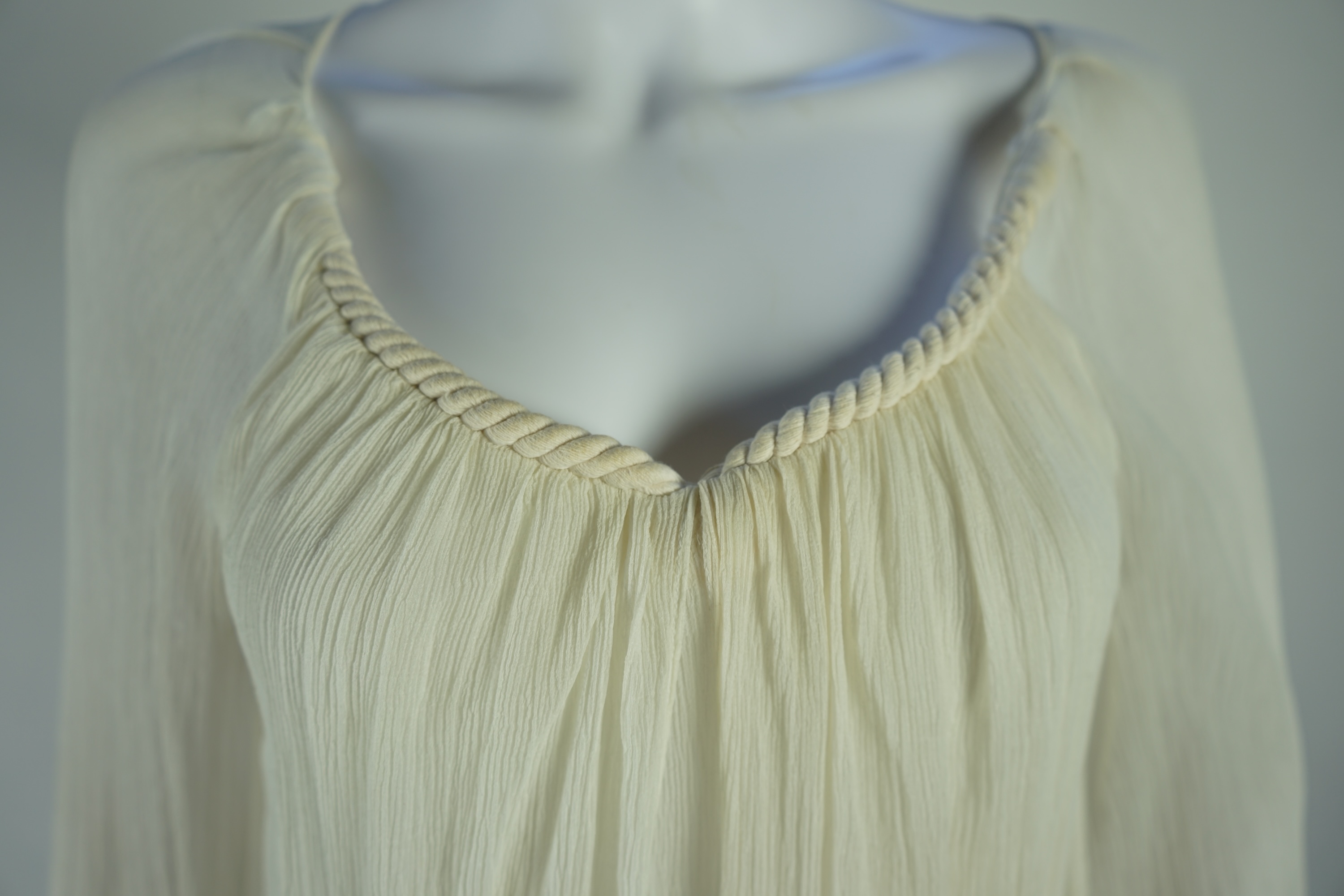 A Diane von Furstenberg cream silk lady's blouse with rope detail, a Dusk for Frank Usher cream silk waistcoat and a white cotton shirt, size 10